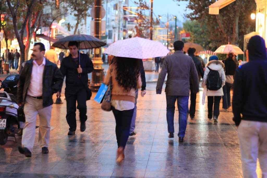 people walking through Istanbul in the rain