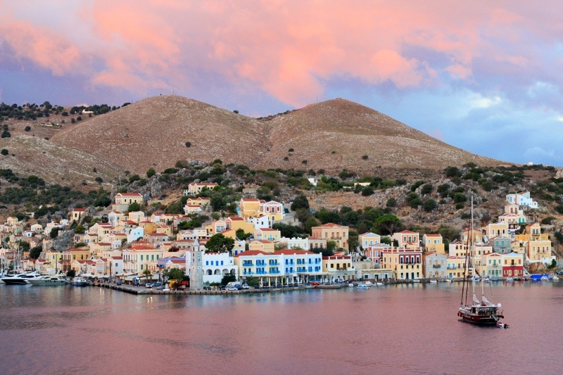 Symi, Greece, at sunrise Symi, Greece, under a pink sunrise.