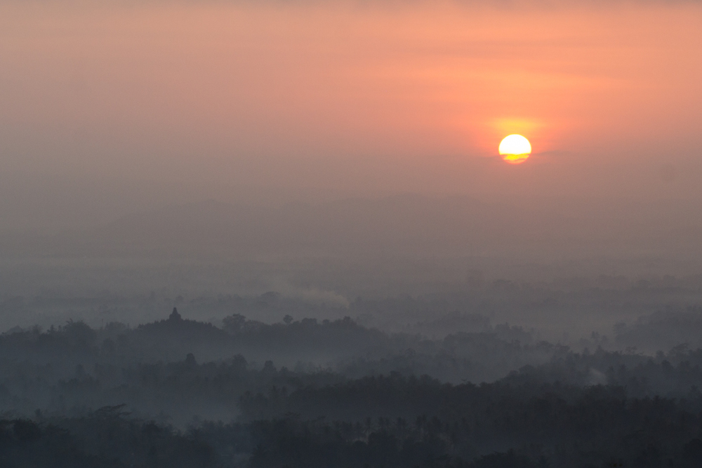 Sunrise over Borobudur from a nearby hill.