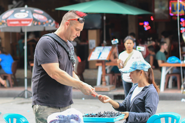 Scorpion Vendor with tourist