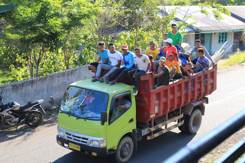 People riding on truck in Indonesia