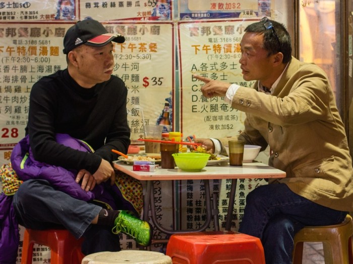 Two men at a cafe in Hong Kong