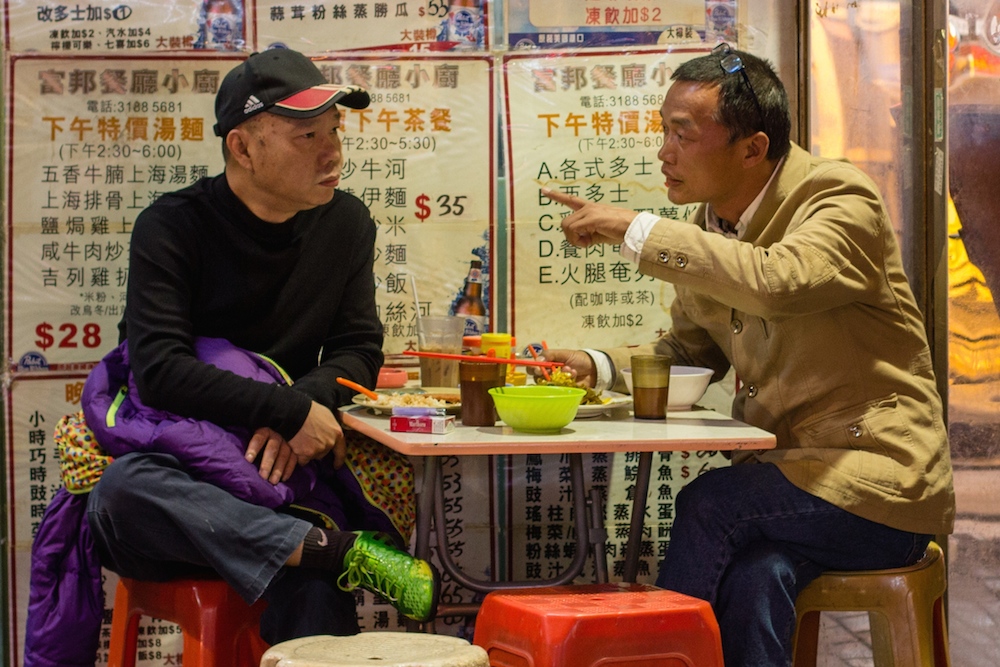 Two men at a cafe in Hong Kong